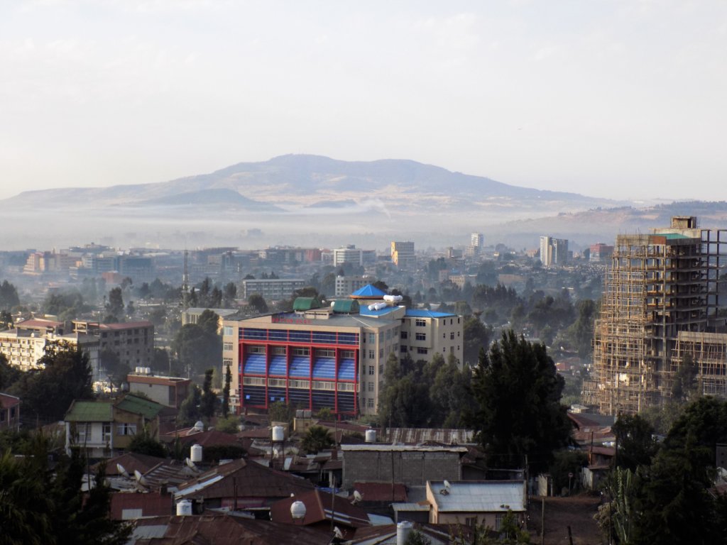 This photo shows the view from our balcony at dawn with the city in the foreground and the mountains in the background