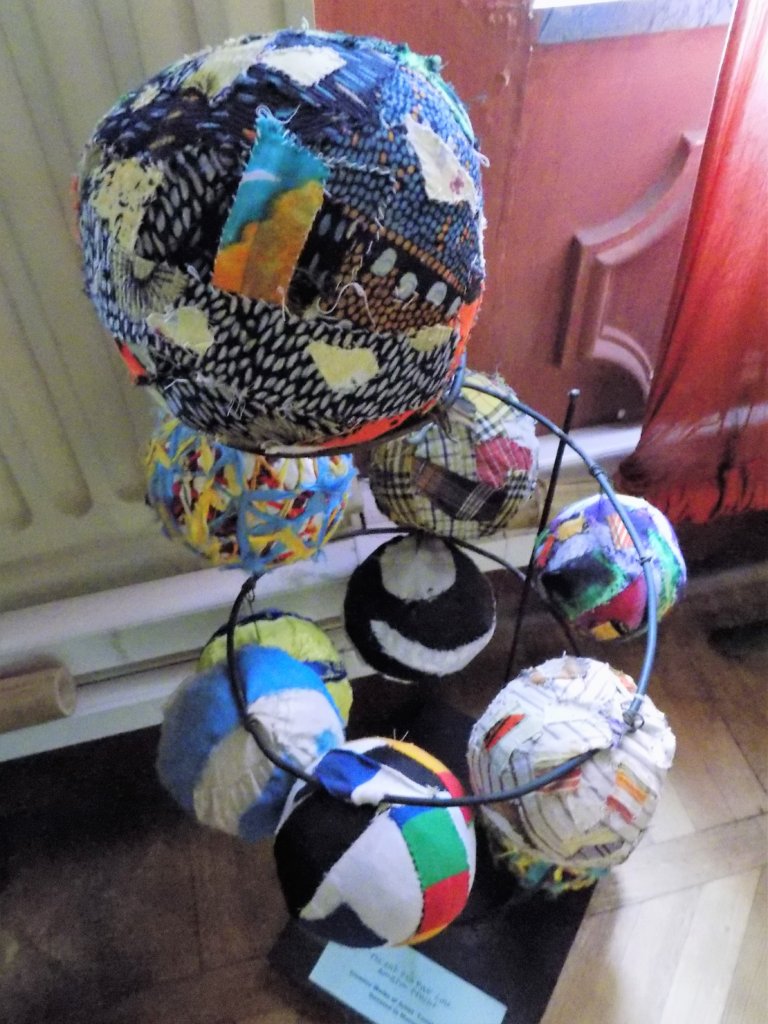 This photo shows a display of footballs made from scraps of fabric