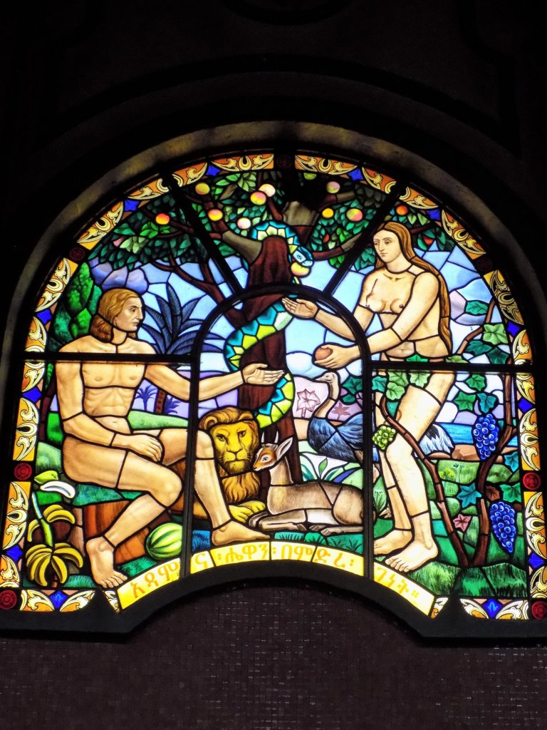 This photo shows a beautiful stained glass window depicting the story of Adam and Eve