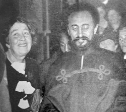 This photo shows a smiling Sylvia standing next to Haile Selassie