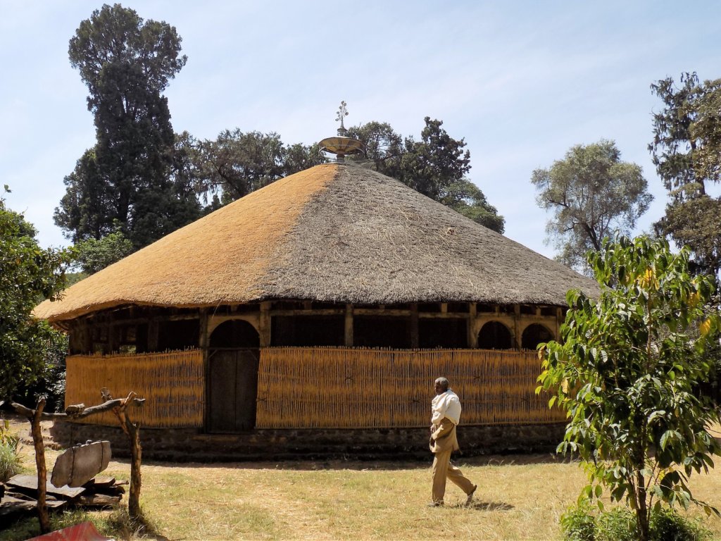 This photo shows the circular Azewa Maryam Church with a beautiful thatched roof