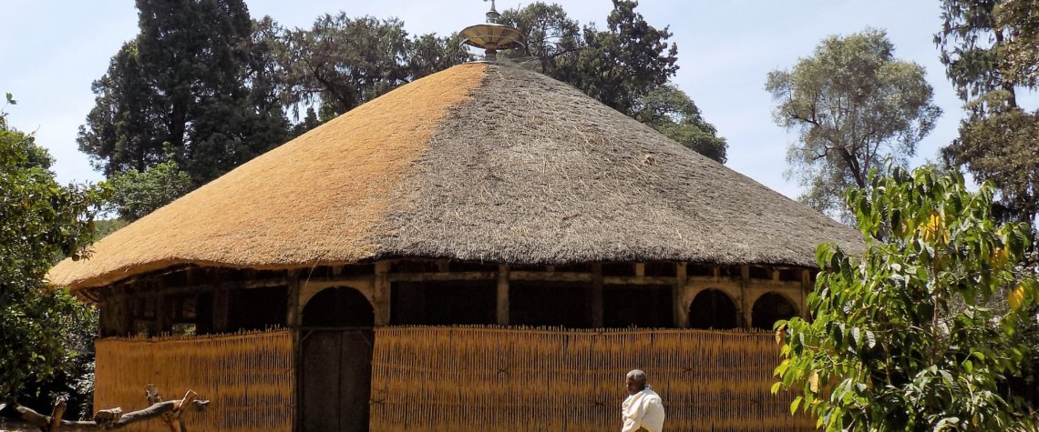 This photo shows the circular Azewa Maryam Church with a beautiful thatched roof
