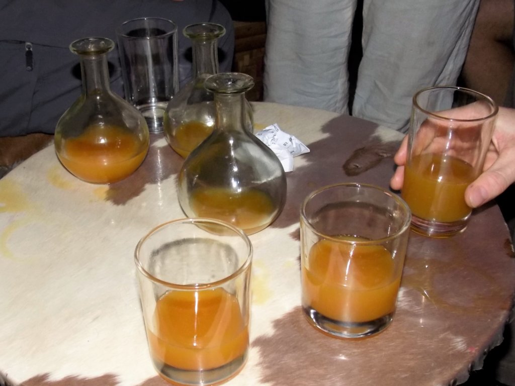 This photo shows flasks and glasses filled with golden tej (honey wine)