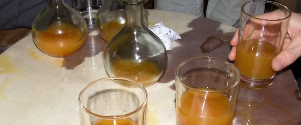 This photo shows flasks and glasses filled with golden tej (honey wine)