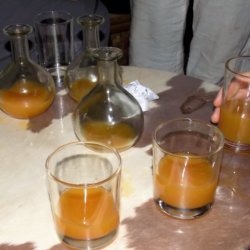 This photo shows flasks and glasses filled with golden tej (honey wine)