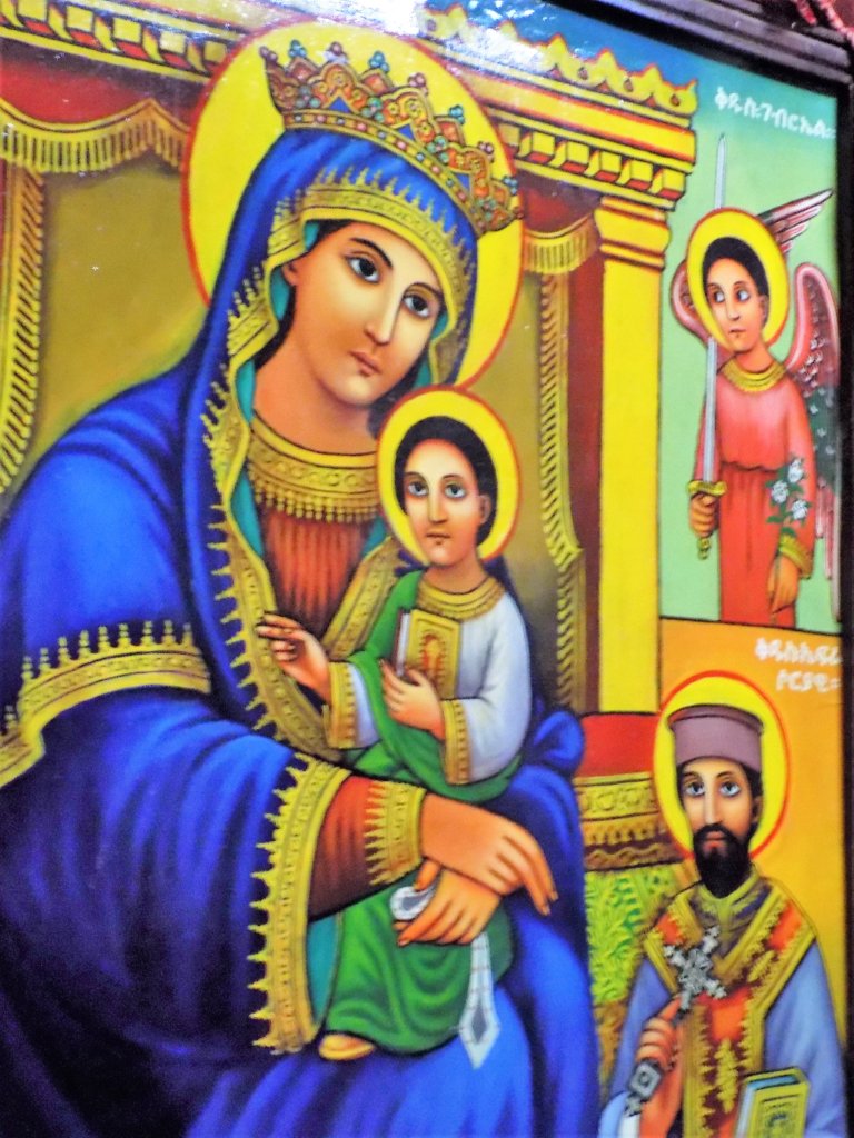 This photo shows a vibrant mural depicting Mary holding the baby Jesus