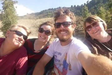 This photo shows Mark and I and a couple of fellow passengers enjoying ourselves on Christie's roof just before I got hit with a rock!