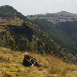 This photo shows an off-duty armed guard relaxing in the Simien Mountains, Ethiopia