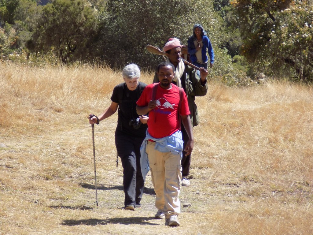 This photo shows a member of our group trekking in single file with our guide in front of her and two armed guards behind her.