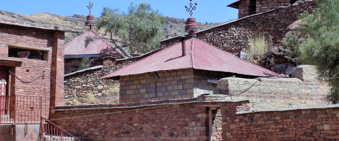 This photo shows the collection of buildings which makes up the Abraha We Atsbeha Church