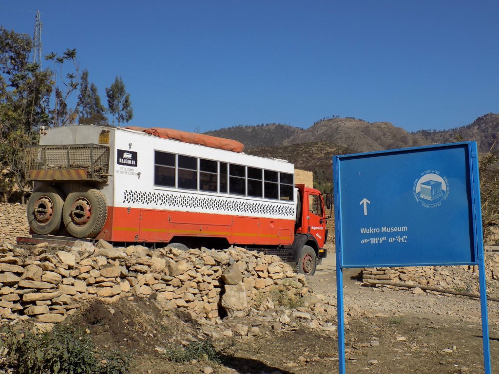 This photo shows our distinctive orange and white overlanding truck parked outside Wukro museum