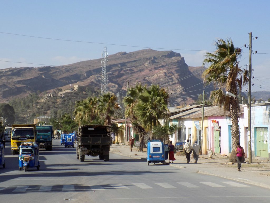 This photo shows Wukro's main street with the ubiquitous blue and white Ethiopian tuk-tuks, trucks and pedestrains