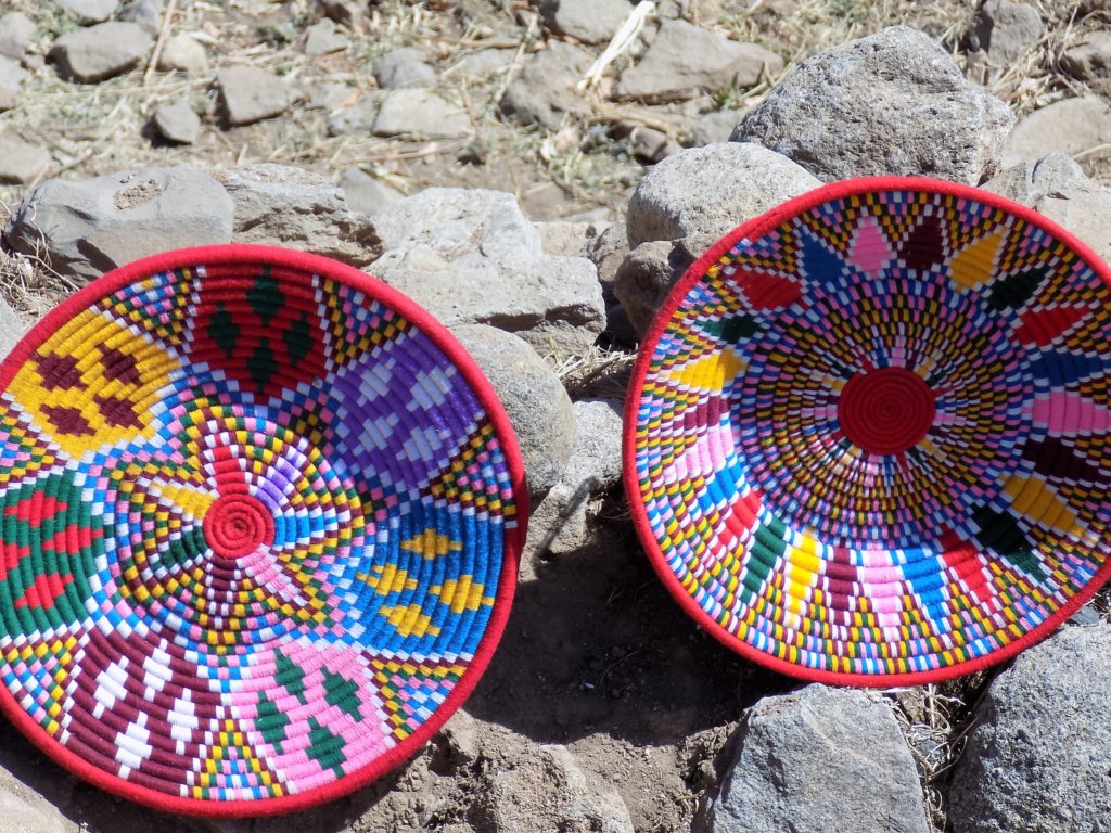 This photo shows two large shallow baskets displayed for sale