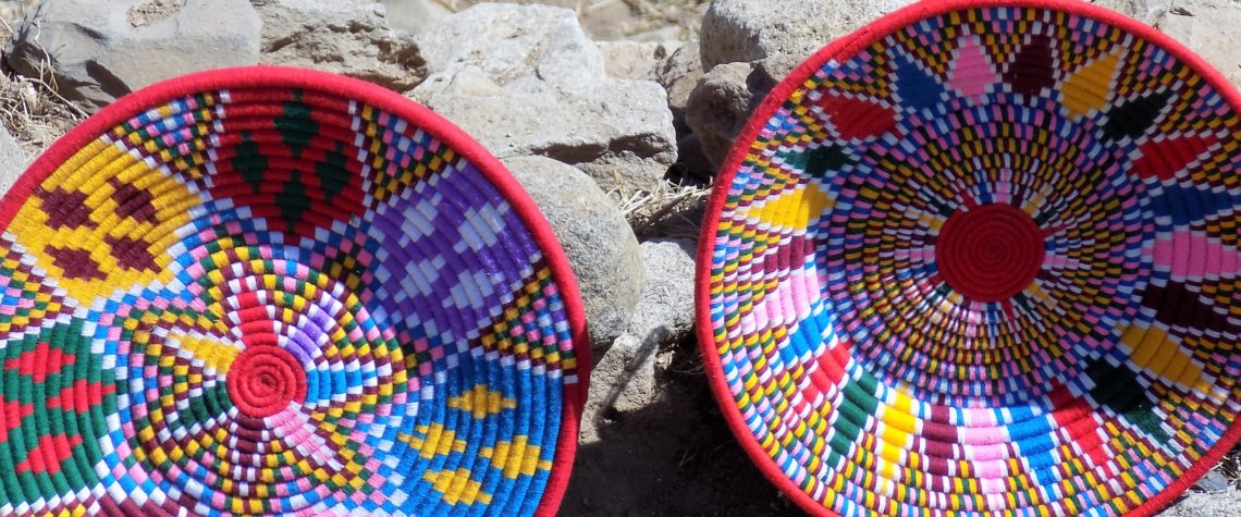 This photo shows two large shallow baskets displayed for sale