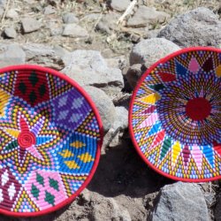This photo shows two large shallow baskets displayed for sale