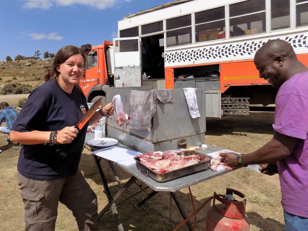 This photo shows Kate, our guide, and David, our driver, jointing the freshly slaughtered lamb ready for cooking over the open fire