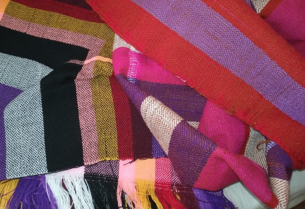 This photo shows gorgeous stripy fabric in purple, pink, red, and black