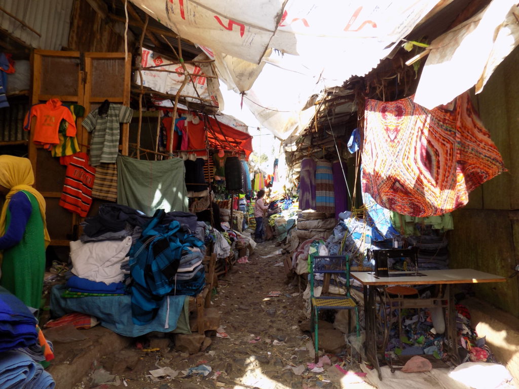 This photo shows jumbled piles of clothes for sale in Gondar market