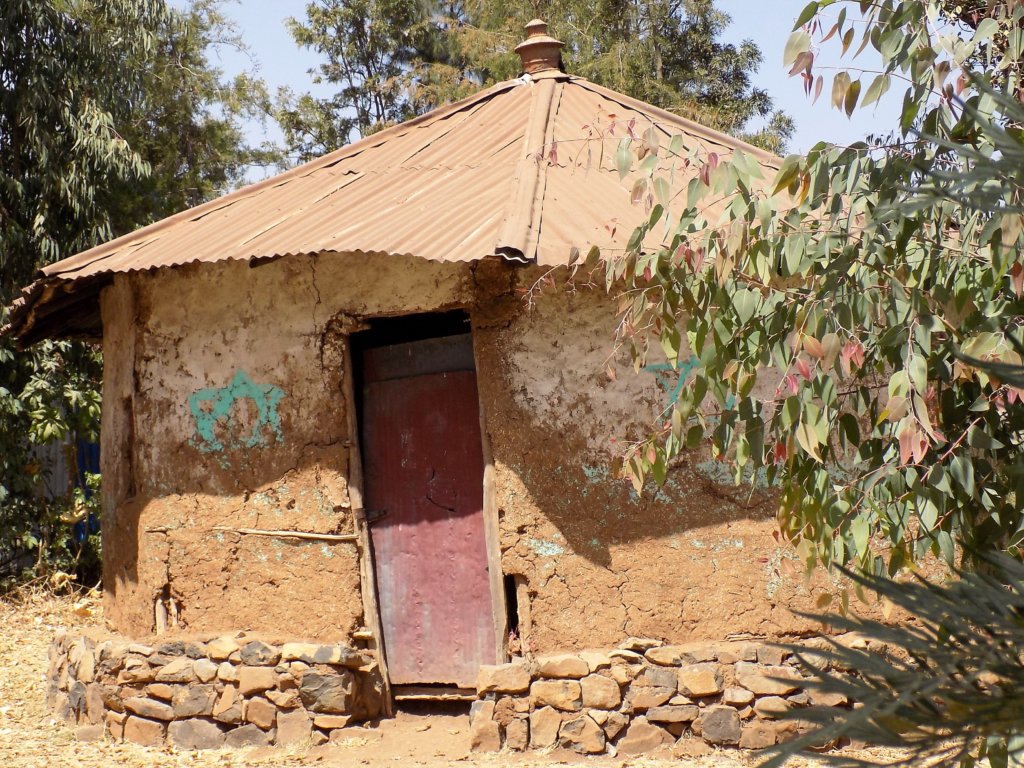 This photo shows a small mud built structure with a corrugated iron roof which served as the synagogue in Wollika