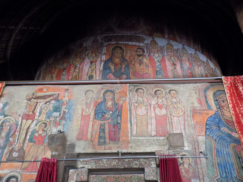 This photo shows colourful murals in the interior of Debre Sina church