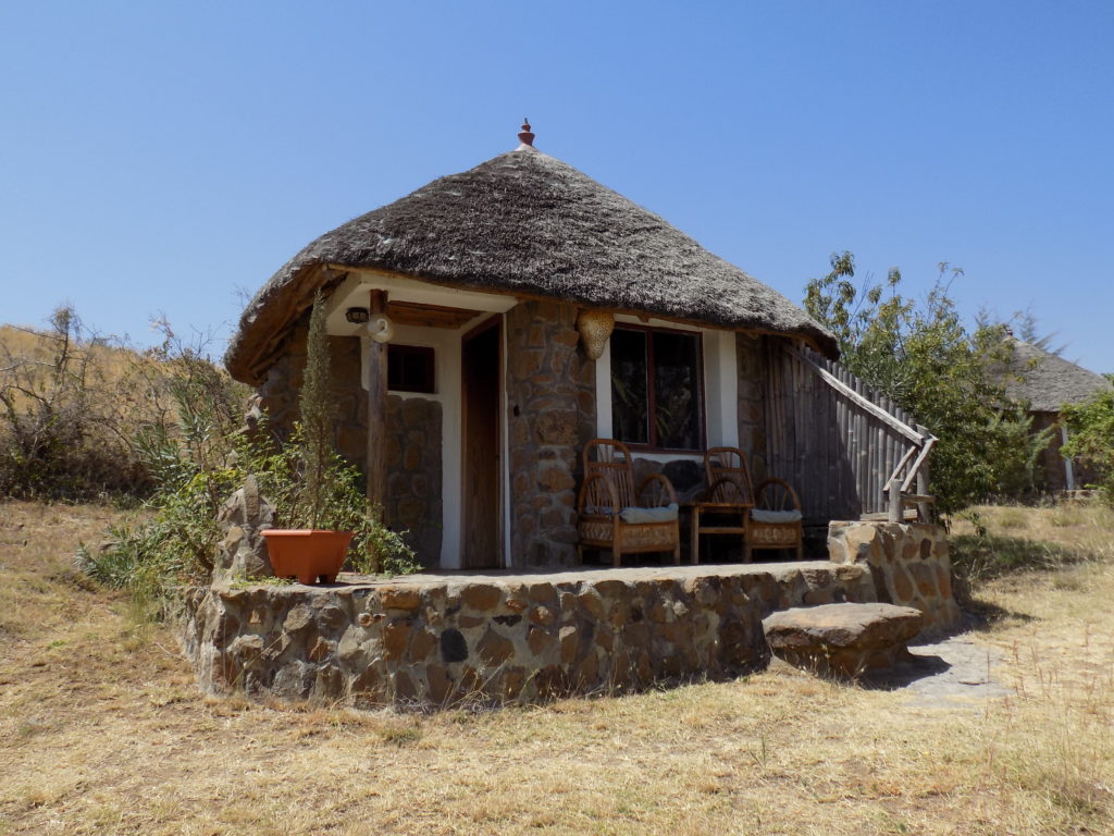 This photo shows one of the individual thatched huts which are the guest accommodation at Tim and Kim Village