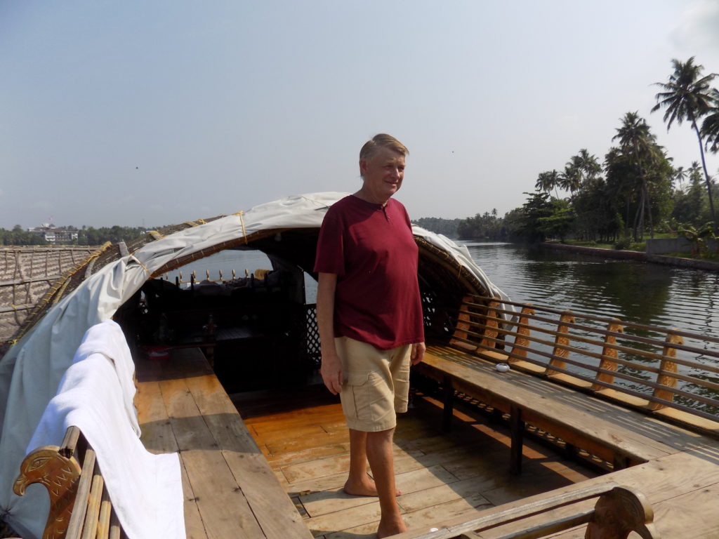 This photo shows Mark standing on the deck of the houseboat