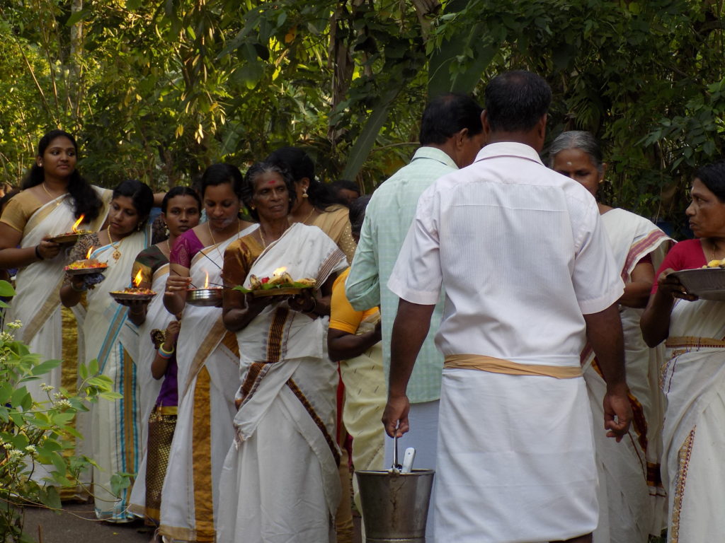 This photo shows local people dressed in white and carrying lit candles