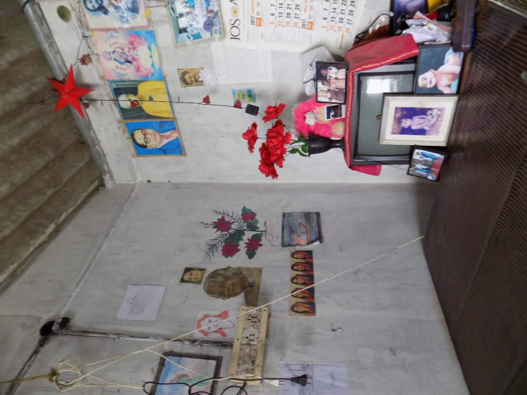 This photo shows Santosh's living room with photos of his children