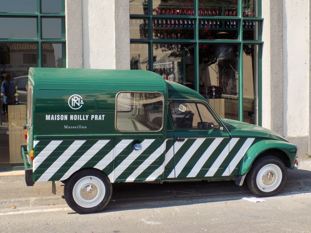 This photo shows a vintage van painted in the green and white colours of Noilly Prat