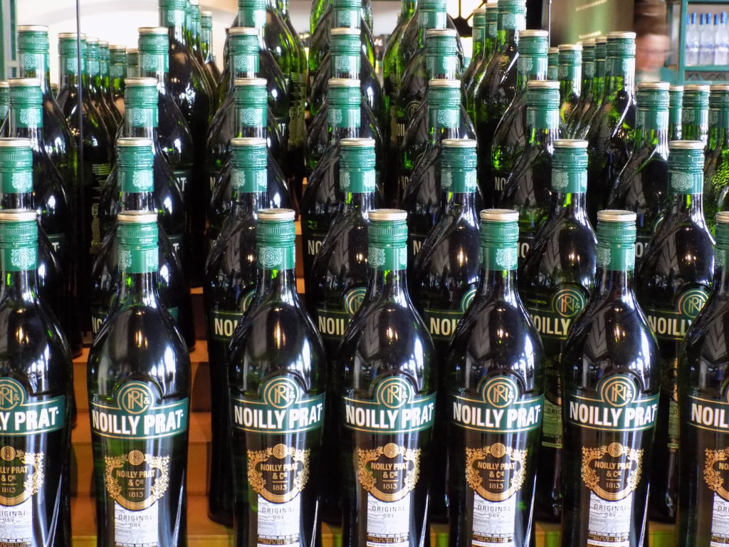 This photo shows rows of the classic Noilly Prat bottles on display in the gift shop