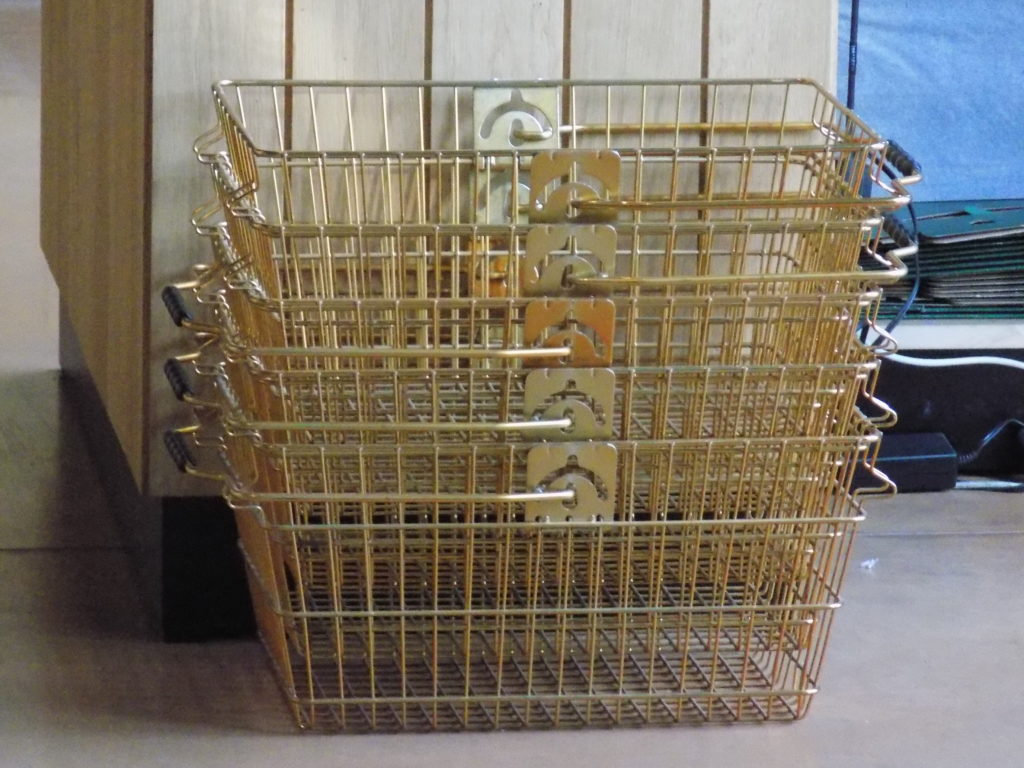 This photo shows some of the gold shopping baskets in the gift shop at the Noilly Prat distillery
