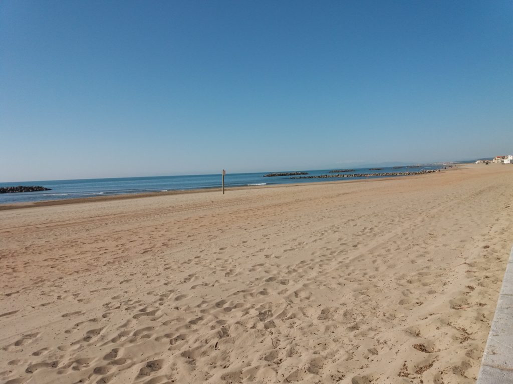 This photo shows the deserted beach at Valras Plage - miles of white sand lapped by the azure blue waters of the Meditteranean