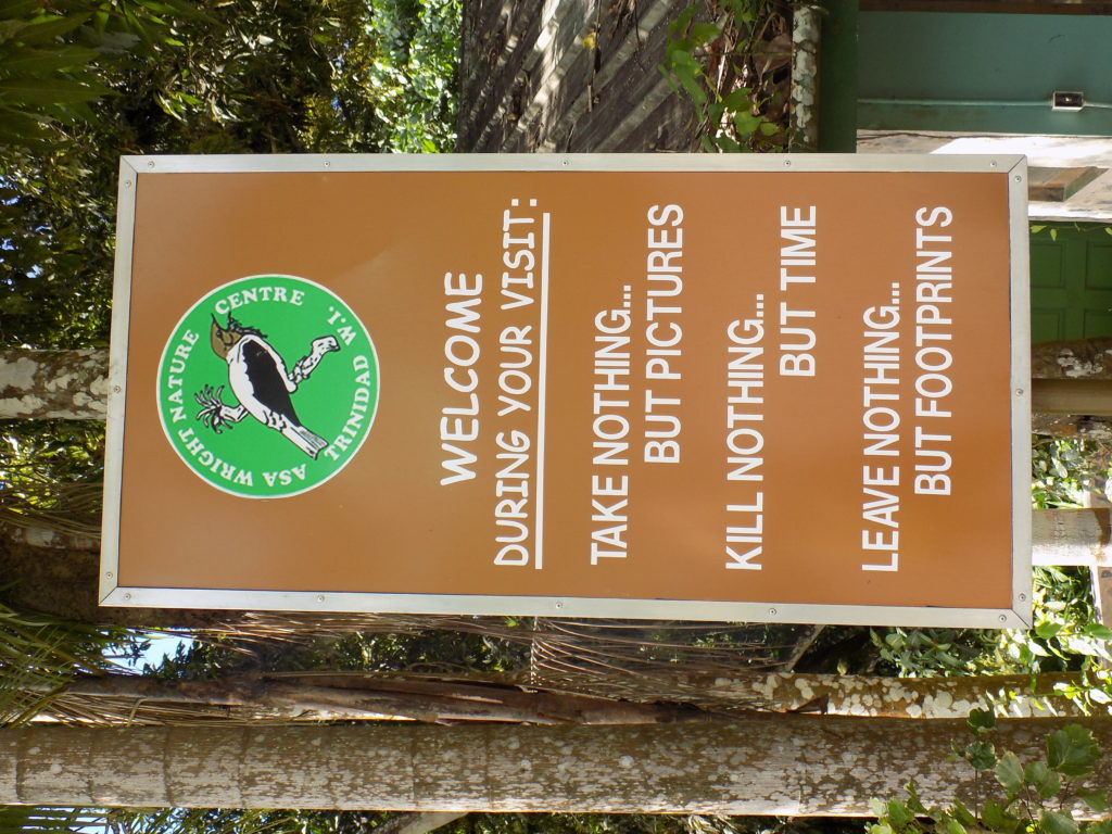 An image of the sign at the entrance to the Asa Wright Centre, Trinidad,urging visitors to take nothing but pictures, kill nothing but time, and leave nothing but footprints.