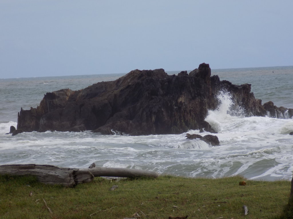 This photo shows a rocky outcrop being battered by the waves.