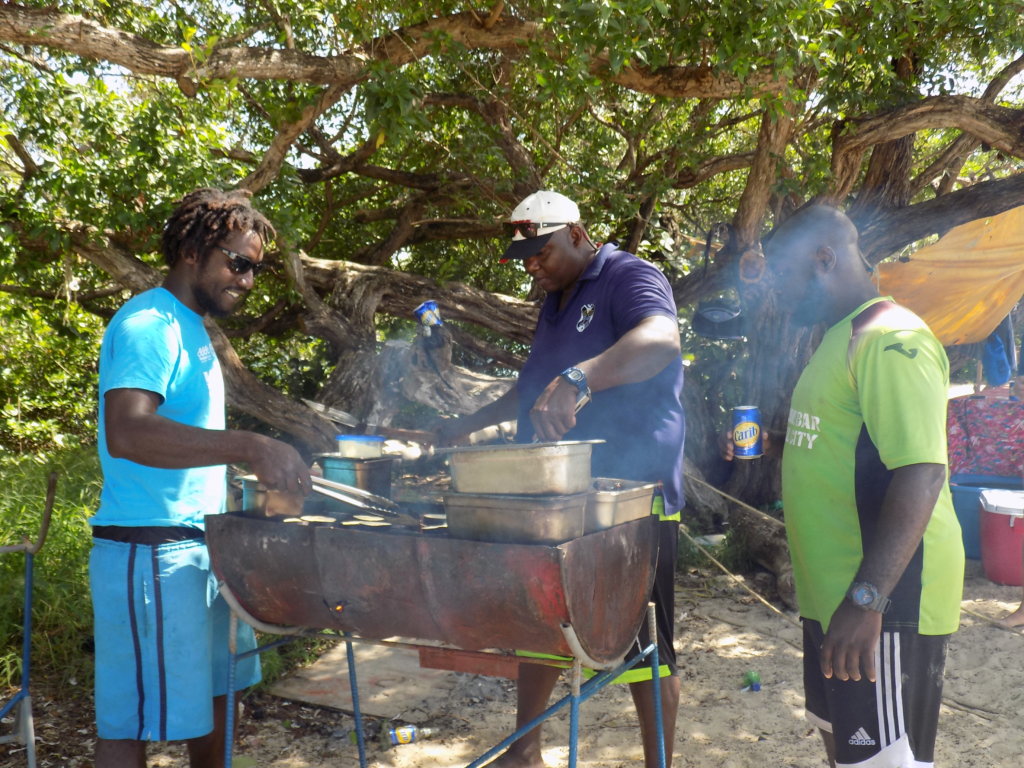 This photo shows Ali Baba cooking fish and chicken on the barbecue