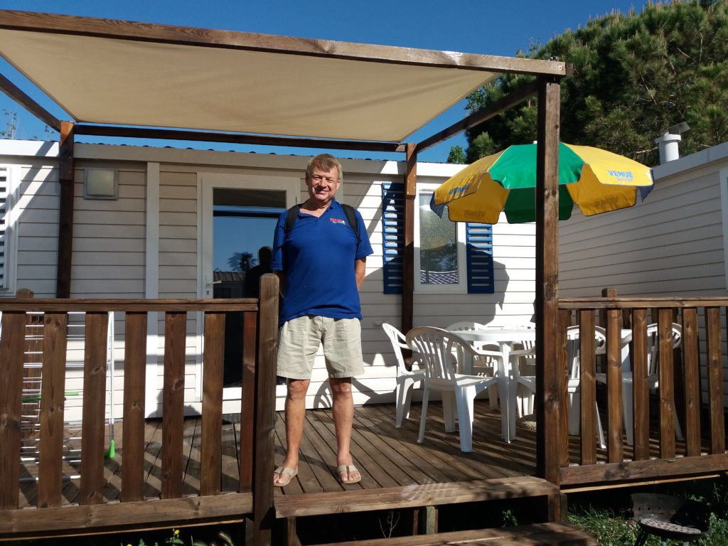 This photo shows Mark standing on the deck of one of our mobile homes in the south of France