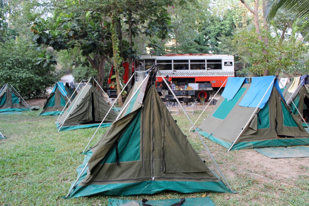 This photo shows a number of tents with a Dragoman truck in the background