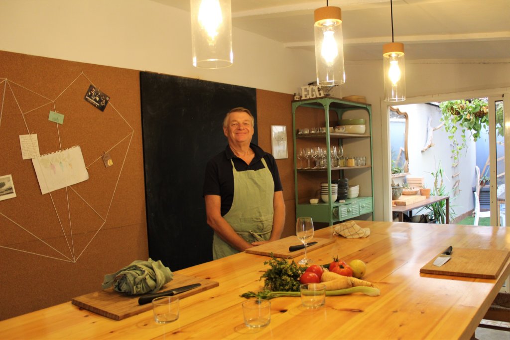This photo shows Mark in his apron standing behind his chopping board awaiting instructions.