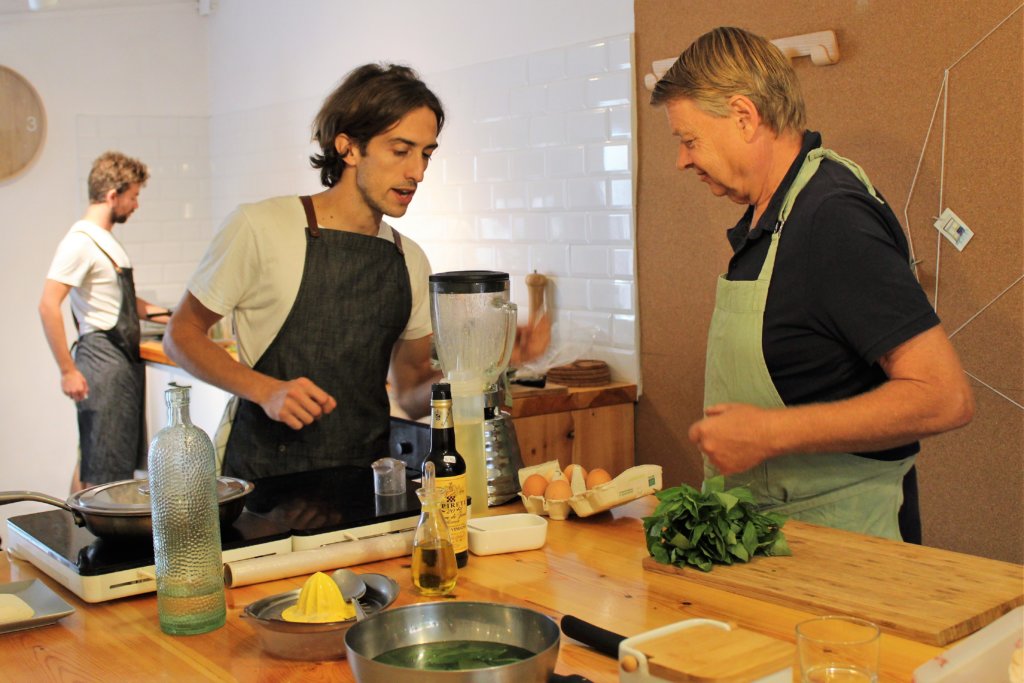 This photo shows Mark and Alberto discussing the correct proportions of egg and oil to make the basil mayonnaise