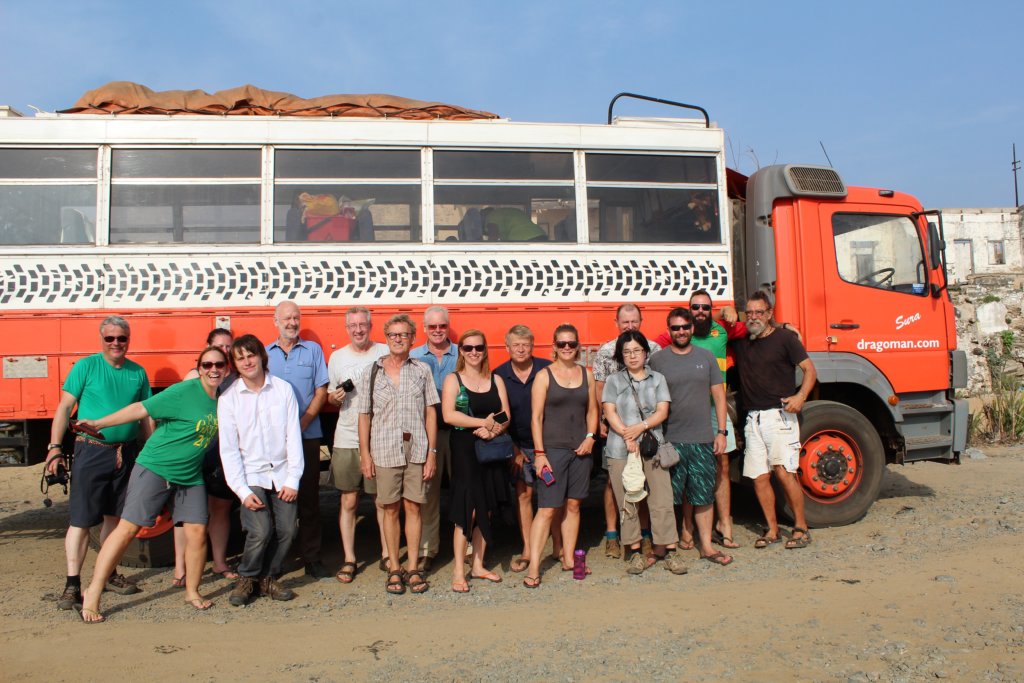 This photo shows a group of Dragoman passengers posing in front of their truck