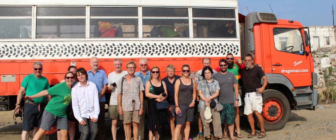 This photo shows a group of Dragoman passengers posing in front of their truck