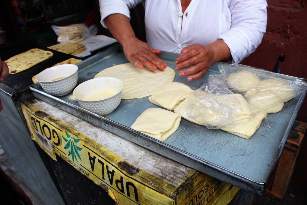 This picture shows a lady shaping traditional Moroccan bread