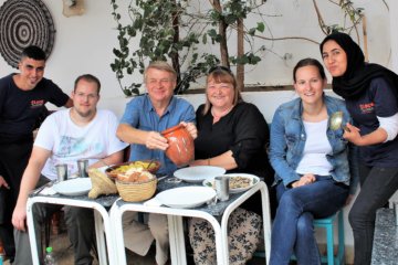 This picture shows the students and teachers enjoying the food they had prepared.