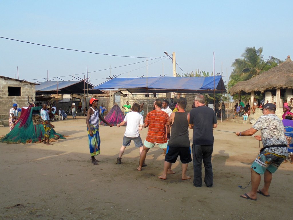 This photo shows six guys from our group pulling on a rope trying to move a Zangbeto