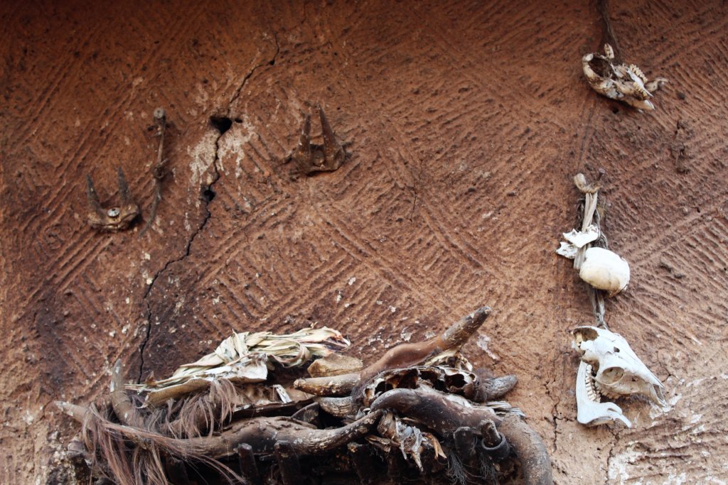 This picture shows animal skulls and bones above the entrance to a tata somba