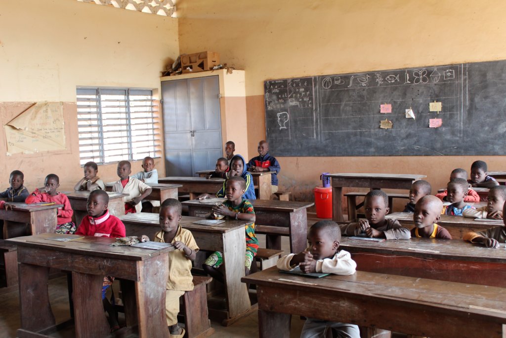 This photo shows a class full of children ready to sing us a song