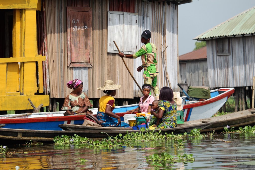 This photo shows a family in a pirogue navigating the waters around Ganvie