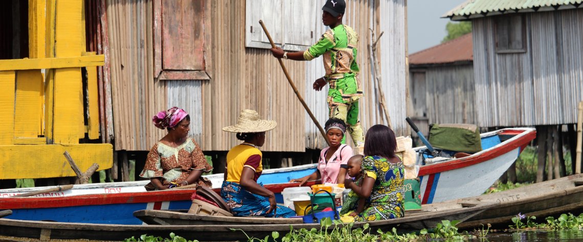 This photo shows a family in a pirogue navigating the waters around Ganvie