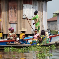 This photo shows a family in a pirogue navigating the waters around Ganvie