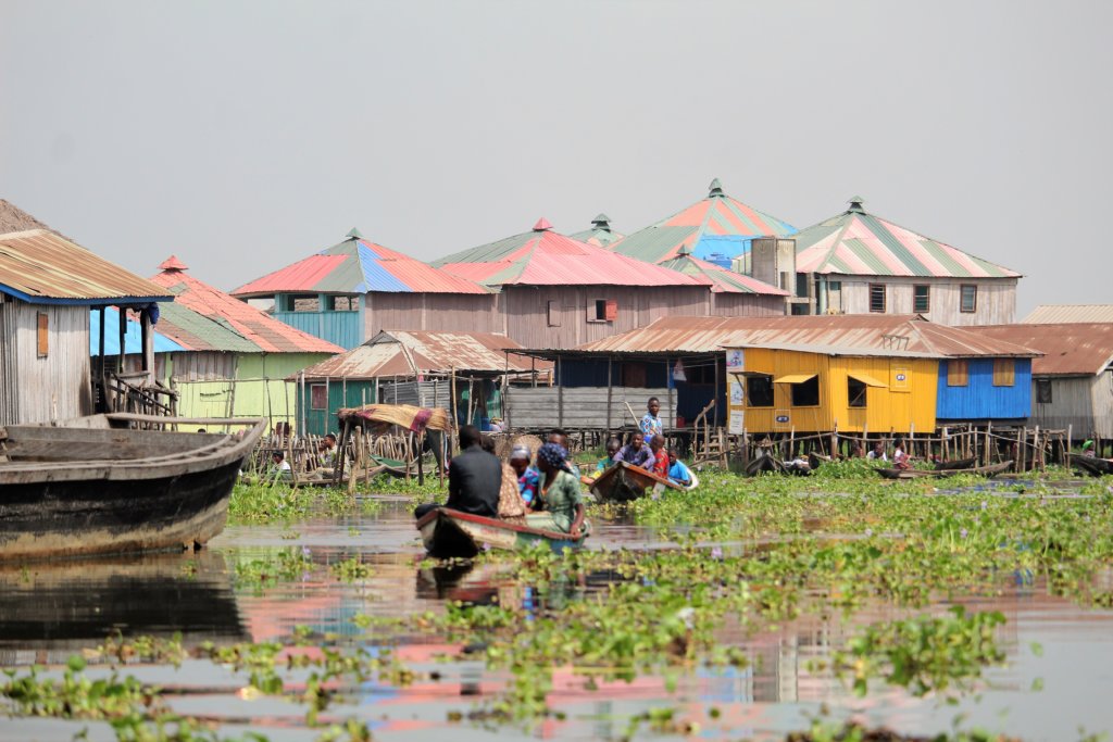 This picture shows the stilt houses of Ganvie with a couple of pirogues in the foreground